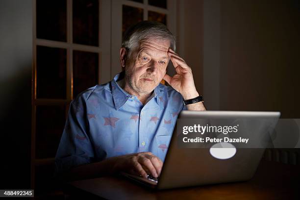 senior man working late - senior using laptop stock pictures, royalty-free photos & images