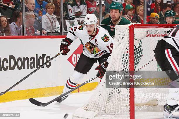 Jonathan Toews of the Chicago Blackhawks skates to the puck with Cody McCormick of the Minnesota Wild defending during Game Three of the Second Round...