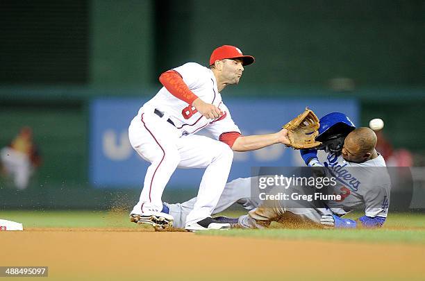 Carl Crawford of the Los Angeles Dodgers is tagged out trying to steal second base in the seventh inning by Danny Espinosa of the Washington...