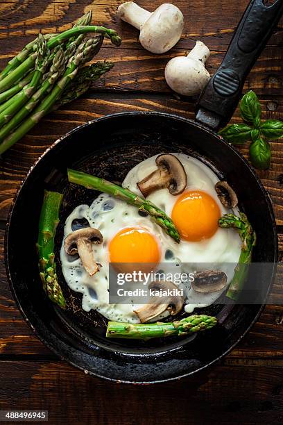fried eggs with asparagus - fried egg stock pictures, royalty-free photos & images