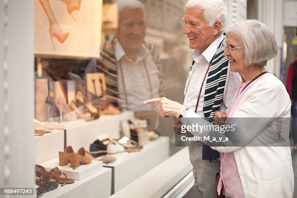 senior couple shopping - seniors shopping stock pictures, royalty-free photos & images