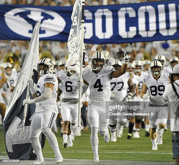 Fred Warner of the Brigham Young Cougars signals to the crowd as he and his team take the field before their game against the Boise State Broncos at...