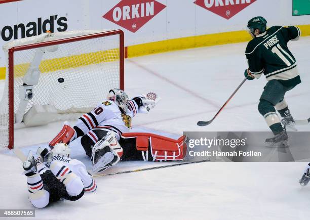 The shot by Mikael Granlund of the Minnesota Wild gets past Brent Seabrook and Corey Crawford of the Chicago Blackhawks as Zach Parise of the...