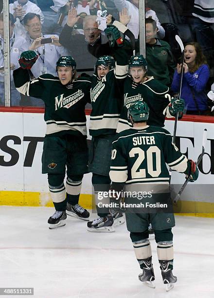 Zach Parise, Mikael Granlund, Jonas Brodin and Ryan Suter of the Minnesota Wild celebrate a goal by Granlund against the Chicago Blackhawks during...