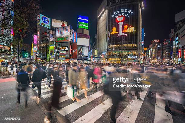 tokyo crowds of people shibuya crossing under neon lights japan - now voyager stock pictures, royalty-free photos & images