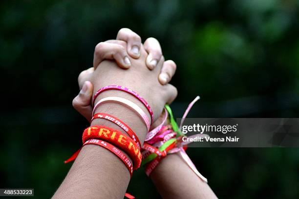 best friends holding hands - bralets stock pictures, royalty-free photos & images