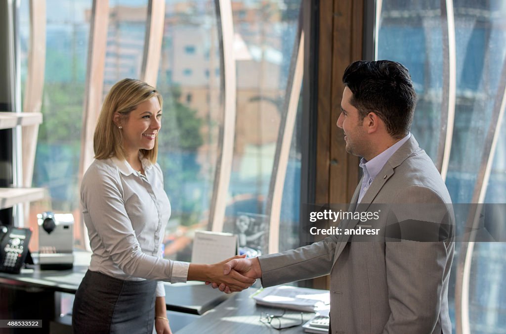 Business woman greeting a client
