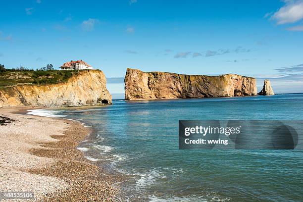 perce' rock taken from the wharf in perce', quebec - perce rock stock pictures, royalty-free photos & images