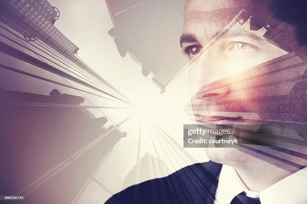 Business man in suit with cityscape montage.