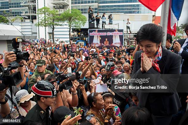 Thai Prime Minister, Yingluck Shinawatra, gives a traditional greeting to her supporters at the Defence Permanent Secretary Office on May 7, 2014 in...