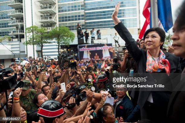 Thai Prime Minister, Yingluck Shinawatra, waves to her supporters at the Defence Permanent Secretary Office on May 7, 2014 in Bangkok, Thailand. Thai...