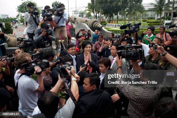 Thai Prime Minister, Yingluck Shinawatra, gives a traditional greeting to her supporters at the Defence Permanent Secretary Office on May 7, 2014 in...