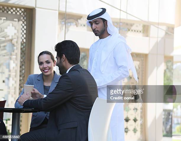 businessman and business woman discussing on the table - bahrain finance stock pictures, royalty-free photos & images