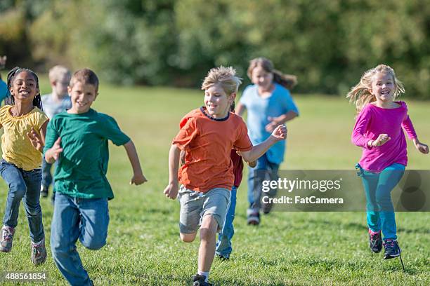 kids playing tag at recess - chase stockfoto's en -beelden