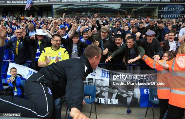 Birmingham manager Lee Clark celebrates with the fans after avoiding relegation following the Sky Bet Championship match between Bolton Wanderers and...