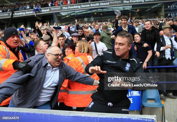 Birmingham manager Lee Clark gets away from an excitable fan after celebrating avoiding relegation following the Sky Bet Championship match between...