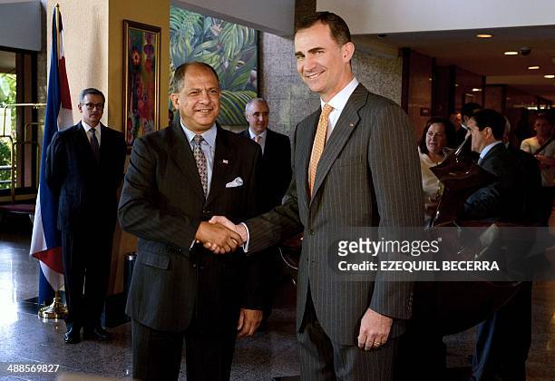 Costa Rica's president elect Luis Guillermo Solis and Spanish Prince Felipe of Borbon shake hands upon the latter's arrival at the hotel in San Jose,...