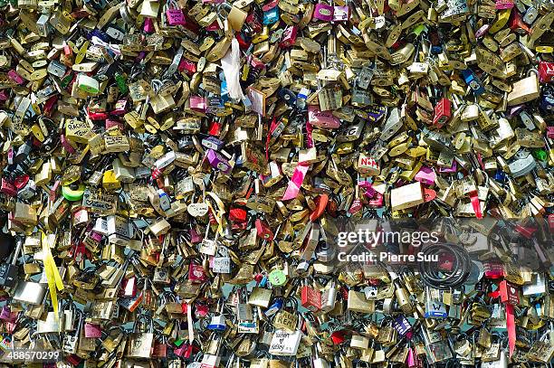 Love Padlocks on the Le Pont Des Arts bridge on May 7, 2014 in Paris, France. In recent years Le Pont Des Arts has attracted tourists who visit the...