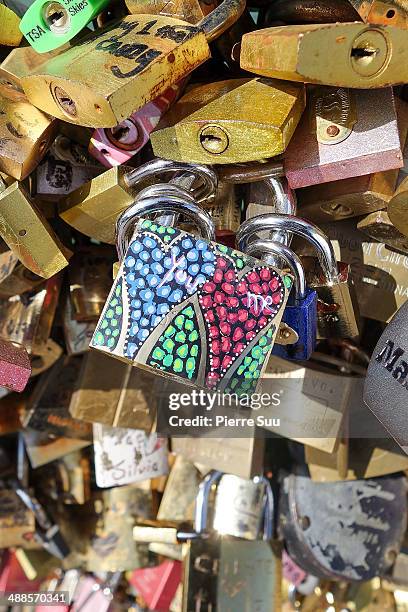 Love Padlocks on the Le Pont Des Arts bridge on May 7, 2014 in Paris, France. In recent years Le Pont Des Arts has attracted tourists who visit the...