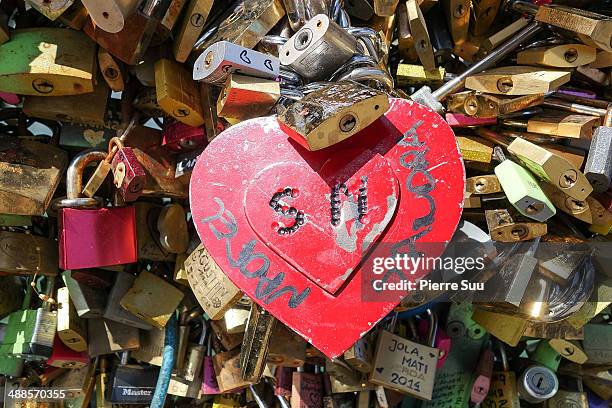 Love Padlocks on the Le Pont Des Arts bridge on May 7, 2014 in Paris, France. In recent years Le Pont Des Arts has attracted tourists who visit the...