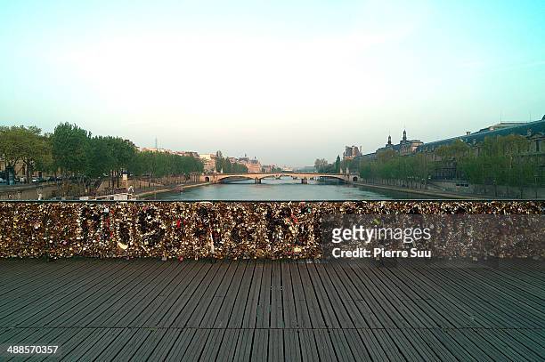 Love Padlocks on the Le Pont Des Arts bridge on May 7, 2014 in Paris, France. In recent years Le Pont Des Arts has attracted tourists who visit the...