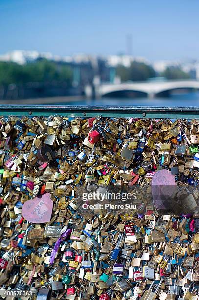 Love Padlocks on the Le Pont Des Arts bridge on May 7, 2014 in Paris, France. In recent years Le Pont Des Arts has attracted tourists who visit the...