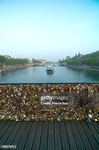 Love Padlocks on the Le Pont Des Arts bridge on May 7, 2014 in Paris, France. In recent years Le Pont Des Arts has attracted tourists who visit the...