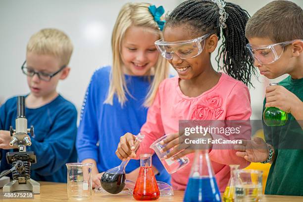 pouring liquid into test tube beakers - science measurement stock pictures, royalty-free photos & images