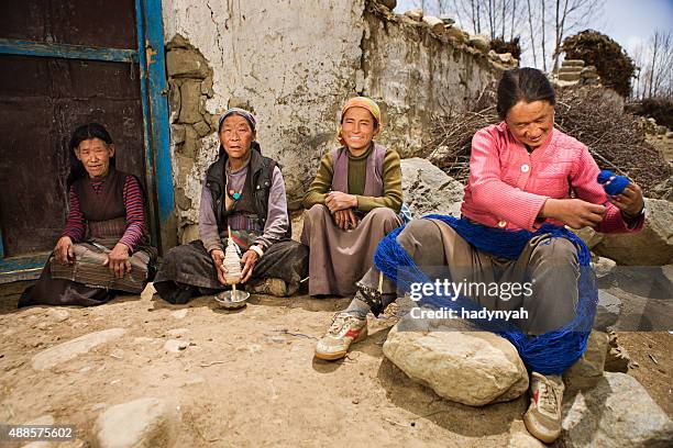 tibetan women spinning wool in mustang region - sherpa nepal stock pictures, royalty-free photos & images