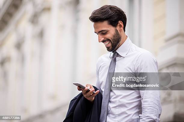 successful businessman with mobile phone - courthouse exterior stock pictures, royalty-free photos & images