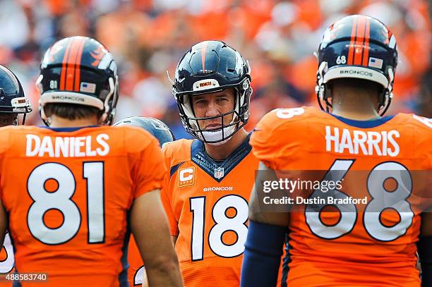 Quarterback Peyton Manning of the Denver Broncos huddles with Owen Daniels and Ryan Harris in the first quarter of a game against the Baltimore...