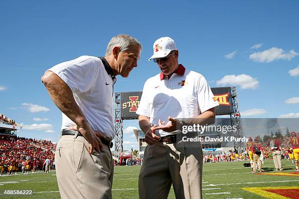Head coach Paul Rhoads of the Iowa State Cyclones, left, meets with head coach Kirk Ferentz of the Iowa Hawkeyes during pre game warm ups before game...