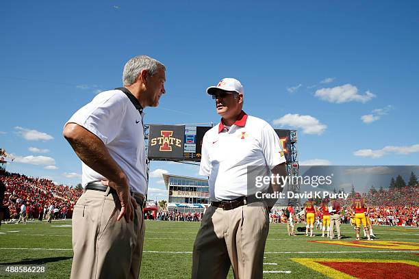 Head coach Paul Rhoads of the Iowa State Cyclones, left, meets with head coach Kirk Ferentz of the Iowa Hawkeyes during pre game warm ups before game...