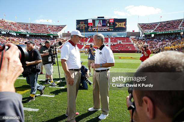 Head coach Paul Rhoads of the Iowa State Cyclones, left, meets with head coach Kirk Ferentz of the Iowa Hawkeyes during pre game warm ups before game...