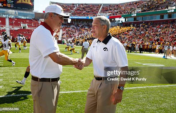 Head coach Paul Rhoads of the Iowa State Cyclones, left, shakes hands with head coach Kirk Ferentz of the Iowa Hawkeyes during pregame warm ups at...