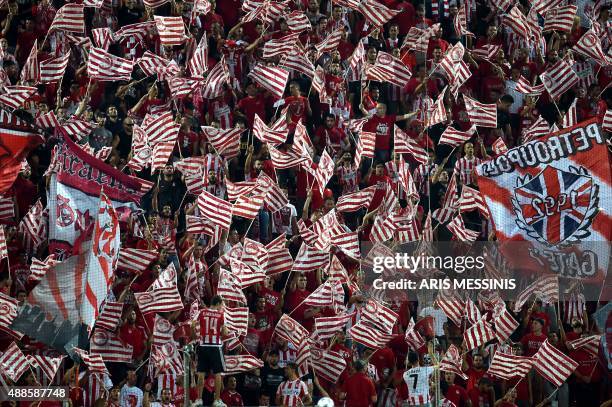 Olympiakos supporters wave flags before a Group F Champions League football game at the Karaiskaki stadium against Bayern Munich in Athens on...