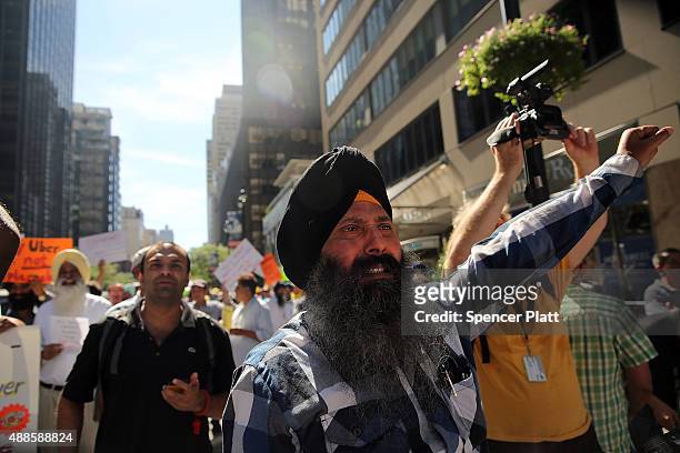 New York City taxi drivers hold a rally in front of Governor Andrew Cuomo's office to protest against recent inroads made by the Uber car service on...