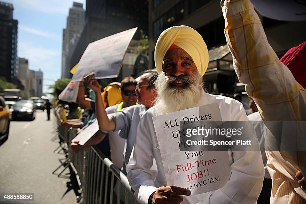 New York City taxi drivers hold a rally in front of Governor Andrew Cuomo's office to protest against recent inroads made by the Uber car service on...