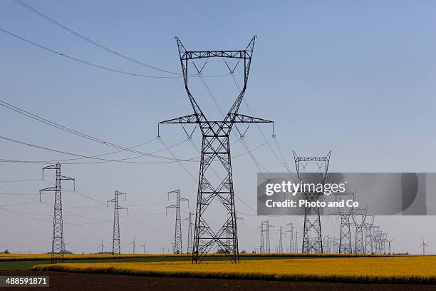 electric pillar and wind turbine - pylone-electrique photos et images de collection