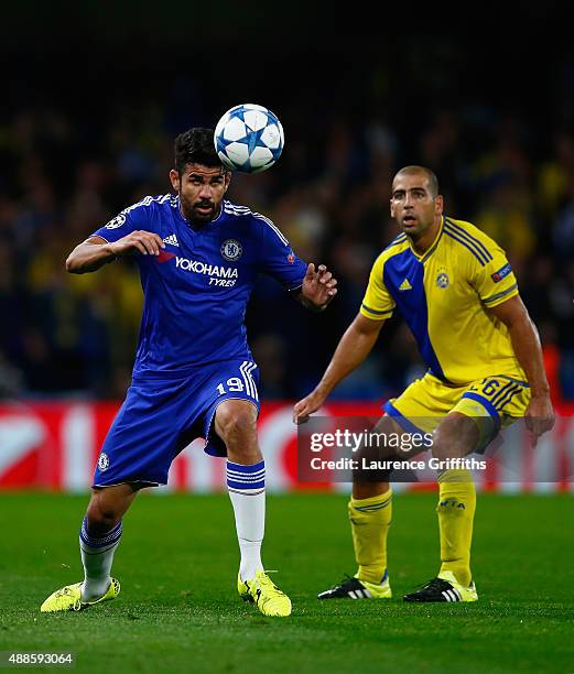 Diego Costa of Chelsea heads the ball under the watchful eye of Tal Ben Haim I of Maccabi Tel Aviv during the UEFA Chanmpions League group G match...