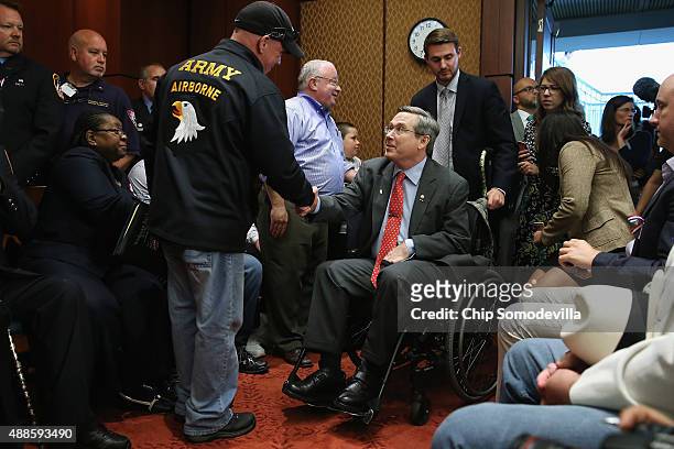 Feel Good Foundation founder John Feel greets Sen. Mark Kirk during a news conference to demand that Congress extend the Zadroga 9/11 health bill at...