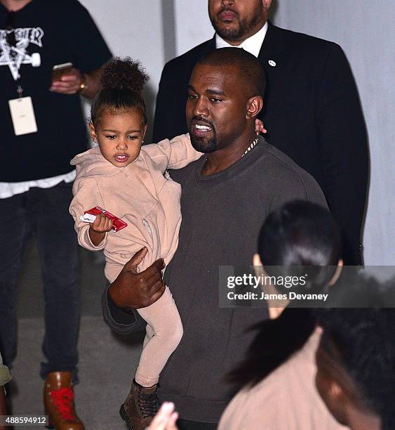 North West, Kanye West and Kim Kardashian leave Kanye West Yeezy Season 2 New York Fashion Week show at Skylight Modern on September 16, 2015 in New...
