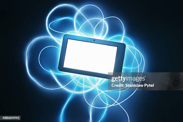 tablet with streaks of light around - virtualitytrend stock pictures, royalty-free photos & images