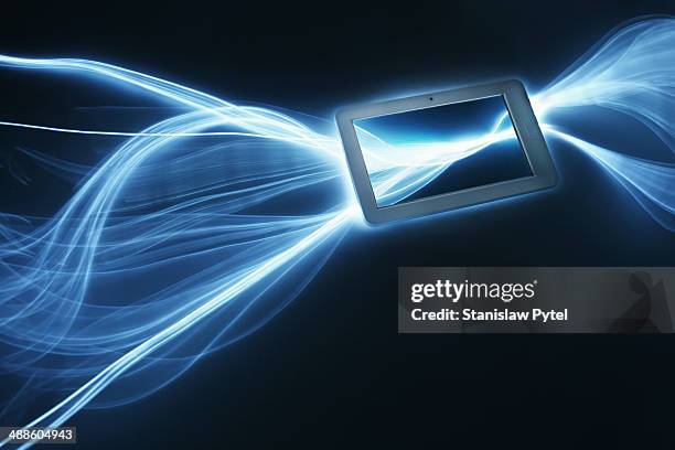 tablet with streaks of light around - virtualitytrend stock pictures, royalty-free photos & images