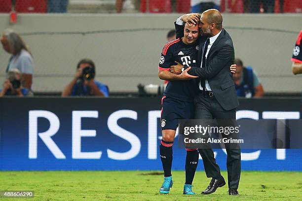 Head coach Pep Guardiola of Muenchen hugs Mario Goetze after the UEFA Champions League Group F match between Olympiacos FC and FC Bayern Muenchen at...