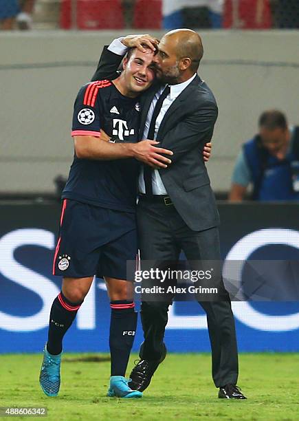 Head coach Pep Guardiola of Muenchen hugs Mario Goetze after the UEFA Champions League Group F match between Olympiacos FC and FC Bayern Muenchen at...