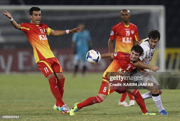 Qatar's Al-Sadd player Raul fights for the ball with Esmaeil Sharifat and Bakhtiar Rahmani of Iran's Foolad Khouzestan during their AFC Champions...