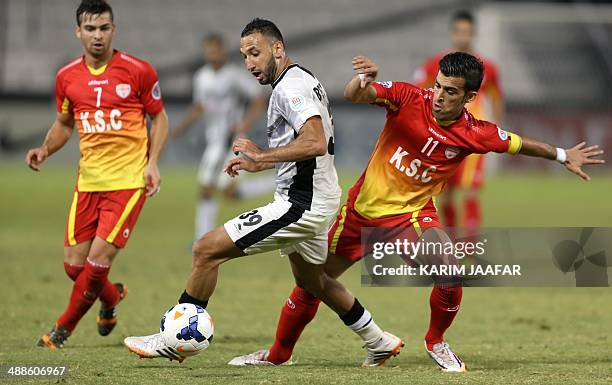 Qatar's Al-Sadd player Nadir Belhadj fights for the ball with Soroush Rafie and Bakhtiar Rahmani of Iran's Foolad Khouzestan during their AFC...
