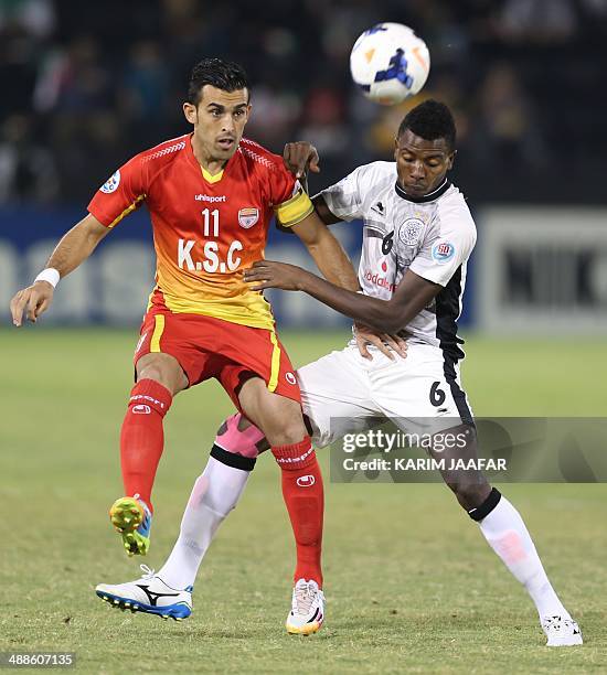 Qatar's Al-Sadd player Mohammed Kasoula fights for the ball with Bakhtiar Rahmani of Iran's Foolad Khouzestan during their AFC Champions League...