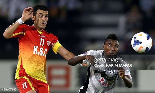 Qatar's Al-Sadd player Mohammed Kasoula fights for the ball with Bakhtiar Rahmani of Iran's Foolad Khouzestan during their AFC Champions League...